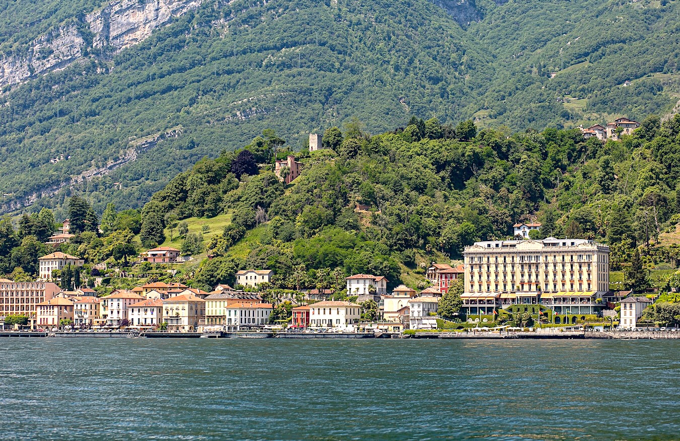 Lake Como waterfront with grand villas and medieval castles on verdant hillsides
